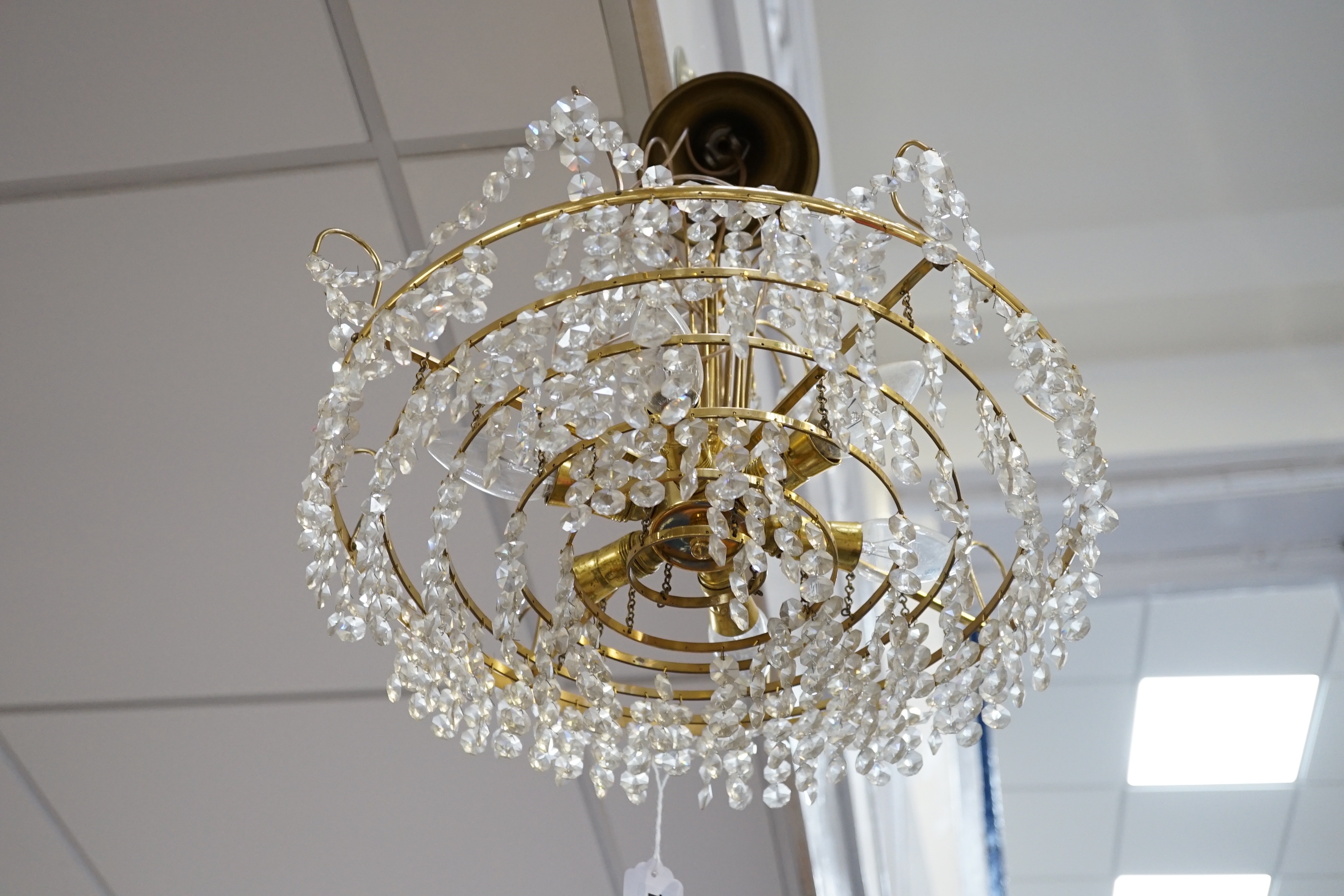 A three tier brass and glass chandelier, 44cm diameter